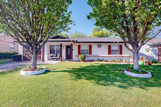 single story home featuring a front lawn, a garage, and aphalt driveway