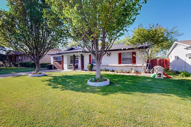 single story home with a front lawn and fence