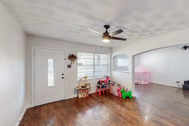 entrance foyer with ceiling fan, wood finished floors, and baseboards