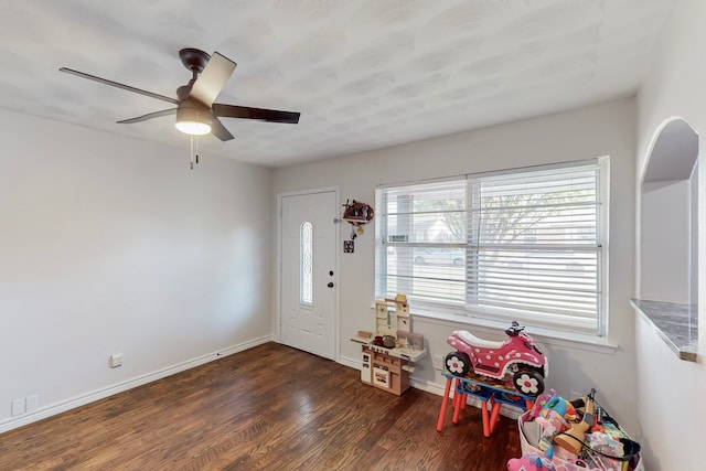 entryway with baseboards, a ceiling fan, and wood finished floors