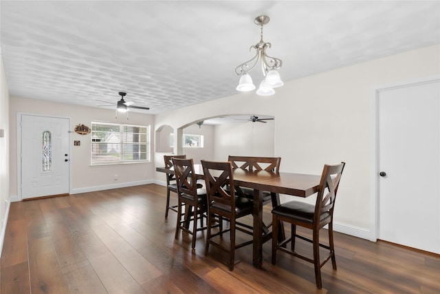 4109 Timberline Dr, Garland, TX 75042 - dining room with a ceiling fan, arched walkways, dark wood-type flooring, and a chandelier