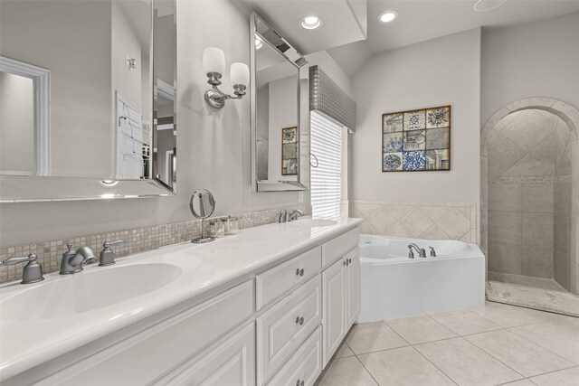 429 S Hampton Ct, Lewisville, TX 75056 - bathroom featuring a sink, a bath, double vanity, and tile patterned flooring