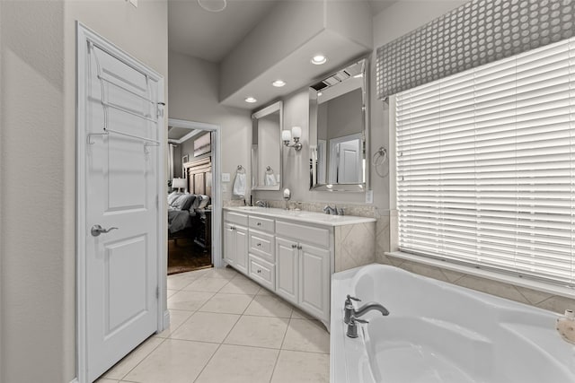 429 S Hampton Ct, Lewisville, TX 75056 - bathroom with double vanity, tile patterned floors, connected bathroom, a bath, and a sink