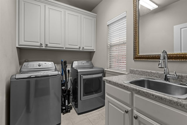 429 S Hampton Ct, Lewisville, TX 75056 - clothes washing area with light tile patterned flooring, a sink, cabinet space, and washing machine and dryer
