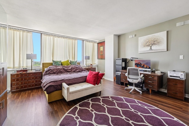 bedroom with dark wood finished floors