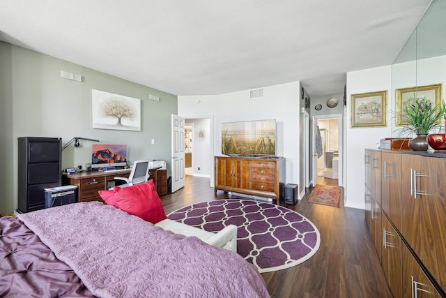 bedroom with visible vents, baseboards, and dark wood-style floors