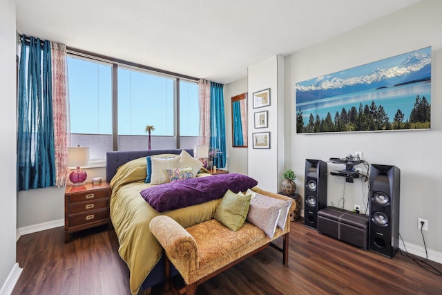 bedroom featuring baseboards and wood finished floors