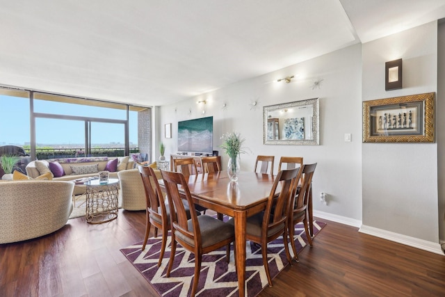 dining room with a wall of windows, dark wood-style flooring, and baseboards