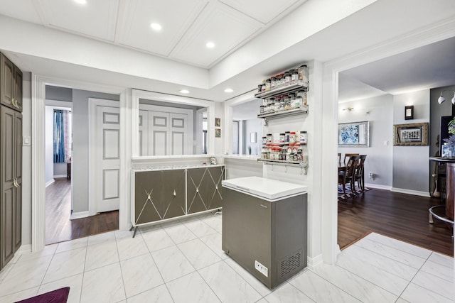 kitchen featuring fridge, light countertops, baseboards, and recessed lighting