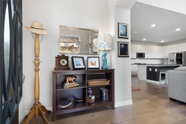 interior space with wood finished floors, baseboards, visible vents, and recessed lighting