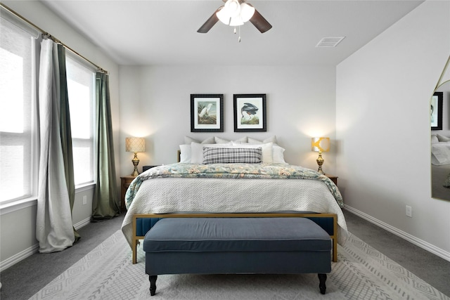 bedroom featuring carpet, visible vents, multiple windows, and baseboards