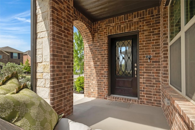 entrance to property with brick siding