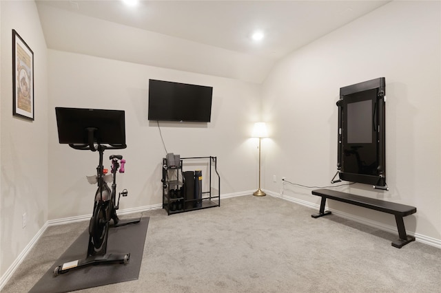 workout area with carpet flooring, baseboards, and vaulted ceiling