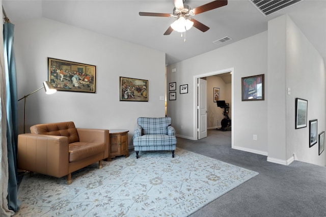 living area with carpet floors, ceiling fan, visible vents, and baseboards