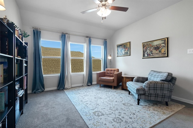 sitting room featuring carpet flooring, baseboards, a ceiling fan, and vaulted ceiling