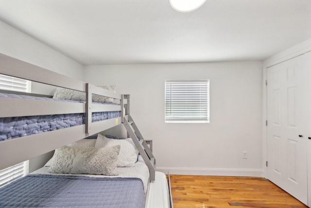 bedroom with wood finished floors and baseboards