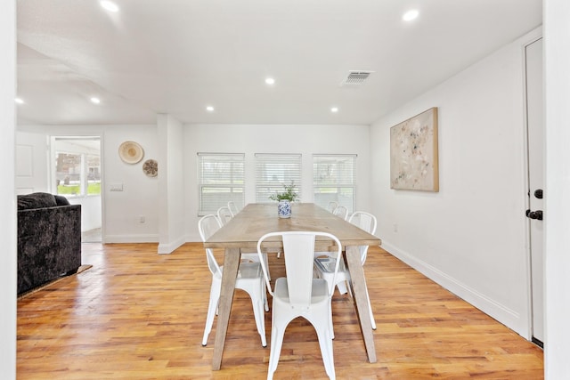 dining space with light wood-style floors, a wealth of natural light, visible vents, and recessed lighting