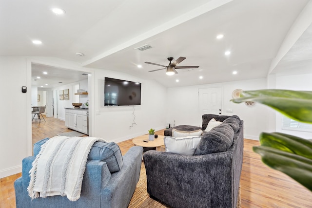 living room with visible vents, light wood-style flooring, a ceiling fan, and recessed lighting