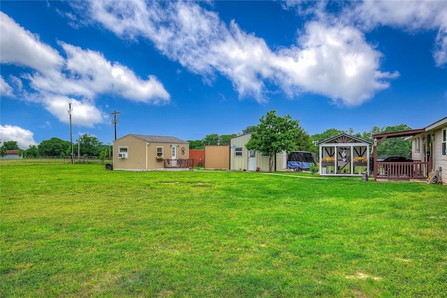 view of yard with an outbuilding and fence