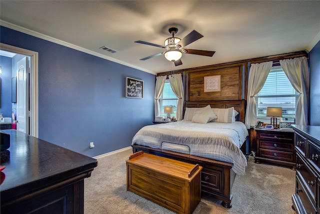 bedroom featuring a ceiling fan, visible vents, crown molding, and carpet floors