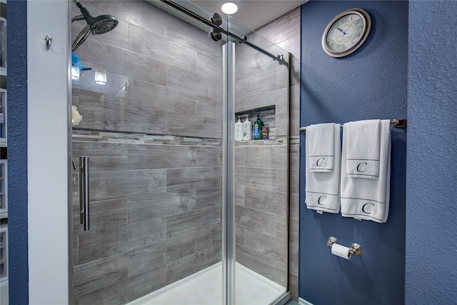 full bath with a stall shower and a textured wall
