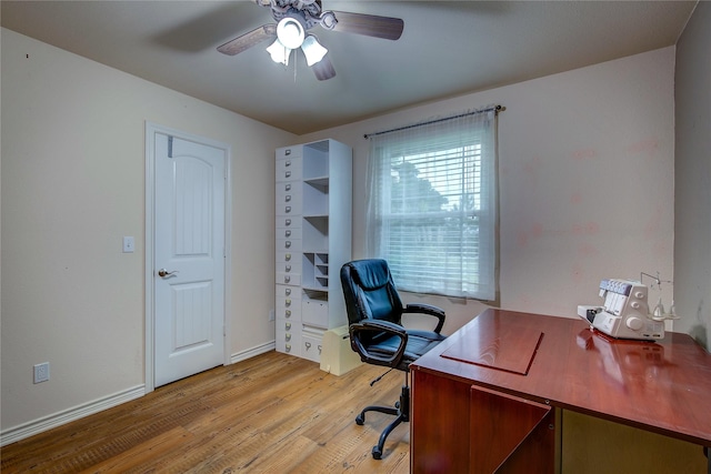 office space featuring a ceiling fan, baseboards, and light wood finished floors