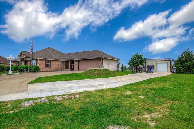 ranch-style house with driveway, brick siding, fence, an outdoor structure, and a front yard