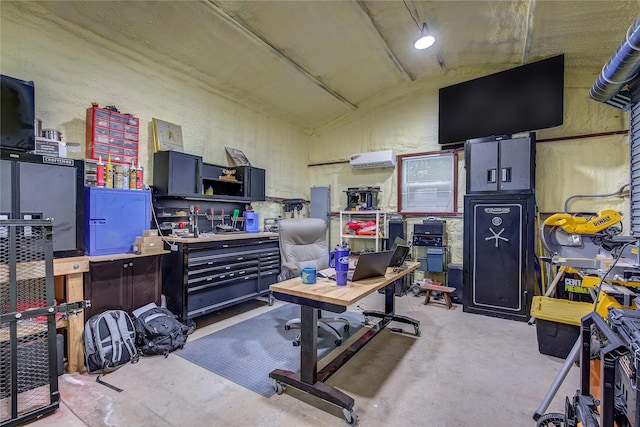 office space featuring lofted ceiling, an AC wall unit, and concrete flooring
