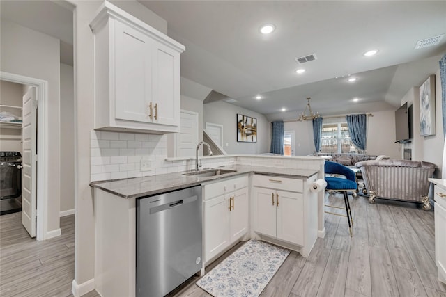 kitchen with stove, visible vents, dishwasher, a sink, and open floor plan