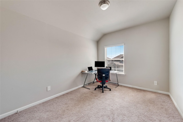 carpeted office featuring baseboards and vaulted ceiling
