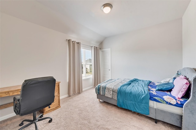 carpeted bedroom with baseboards and vaulted ceiling