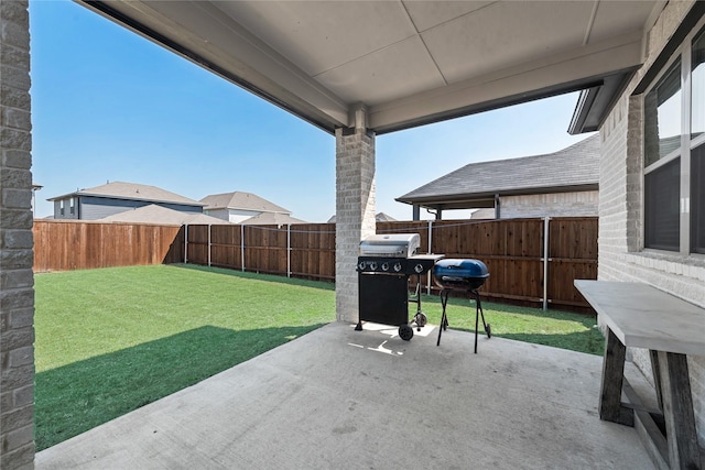 view of patio / terrace with a fenced backyard and a grill