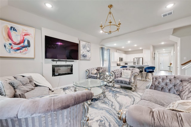 living area featuring recessed lighting, a notable chandelier, and visible vents