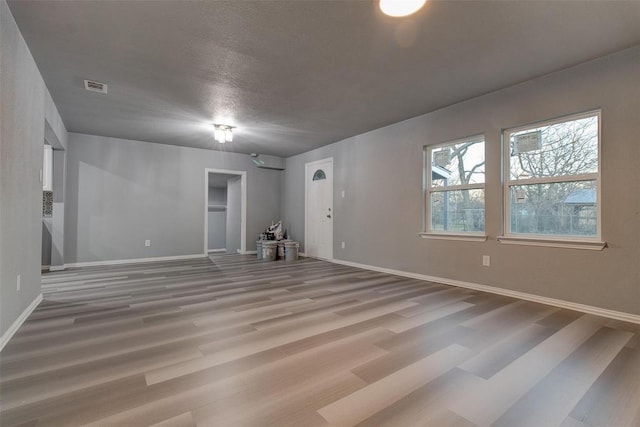 702 N Virginia, Terrell, TX 75160 - empty room featuring a textured ceiling, wood finished floors, baseboards, and visible vents