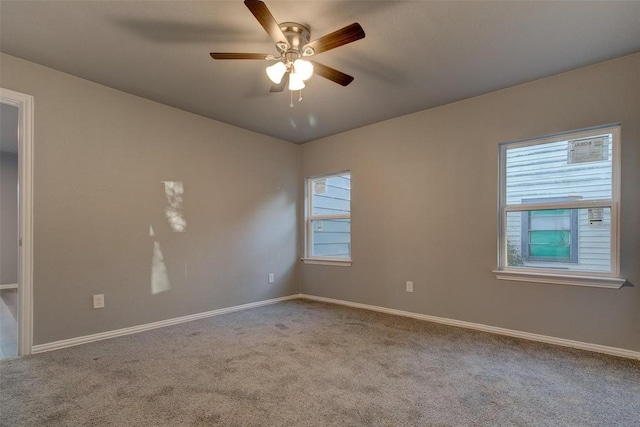702 N Virginia, Terrell, TX 75160 - spare room featuring carpet floors, baseboards, and a ceiling fan