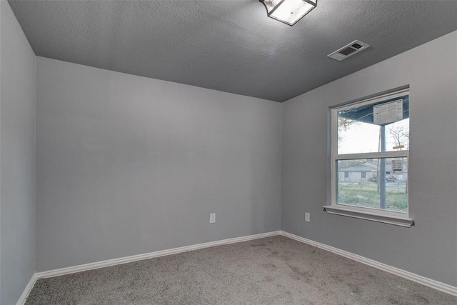 702 N Virginia, Terrell, TX 75160 - carpeted spare room featuring visible vents, baseboards, and a textured ceiling