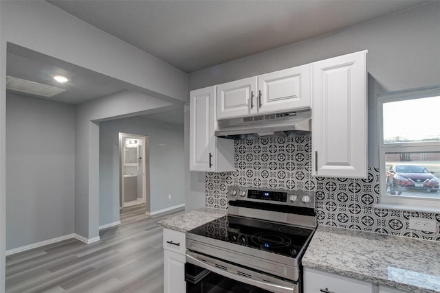 702 N Virginia, Terrell, TX 75160 - kitchen with tasteful backsplash, baseboards, stainless steel electric range, white cabinets, and under cabinet range hood