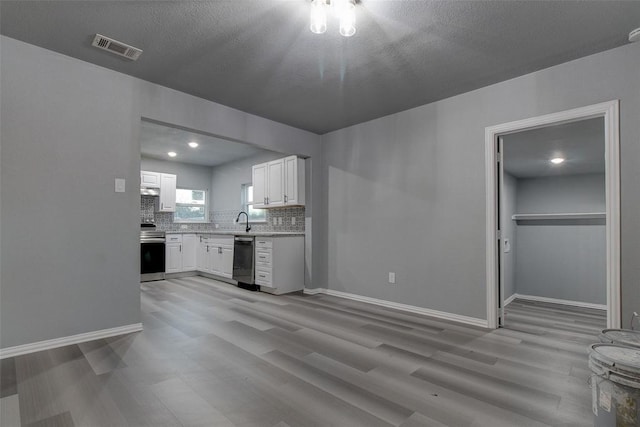 702 N Virginia, Terrell, TX 75160 - kitchen featuring electric range, white cabinetry, visible vents, dishwasher, and backsplash