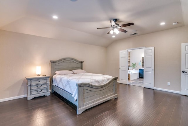 full bath featuring a tile shower, a bath, vanity, stone finish flooring, and vaulted ceiling