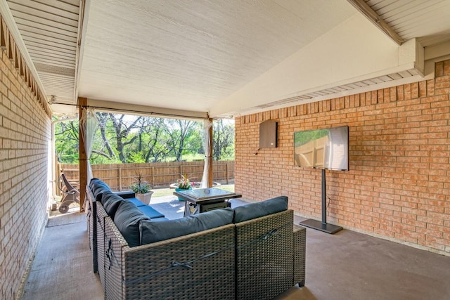 view of patio with an outdoor living space and fence