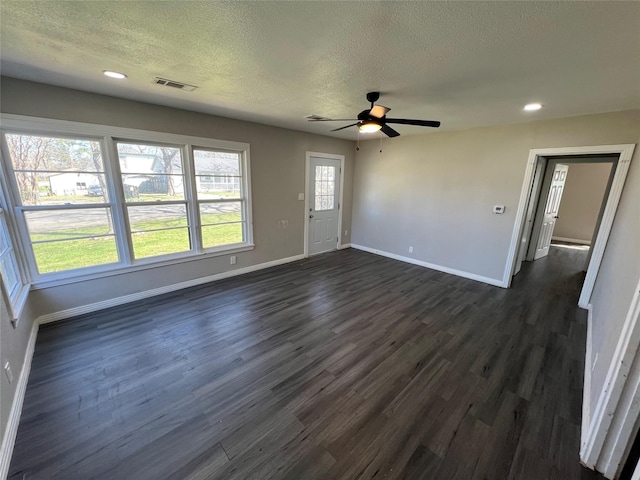 2912 W Elm St, Denison, TX 75020 - unfurnished living room with a textured ceiling, baseboards, a ceiling fan, and visible vents