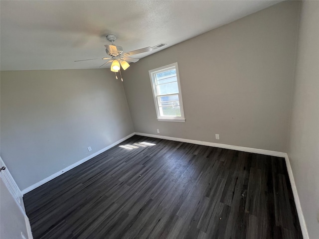 2912 W Elm St, Denison, TX 75020 - unfurnished room featuring dark wood-style flooring, baseboards, and a ceiling fan