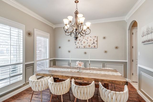 500 Lismore Dr, Mansfield, TX 76063 - dining room featuring dark wood-style flooring, a chandelier, crown molding, a decorative wall, and arched walkways