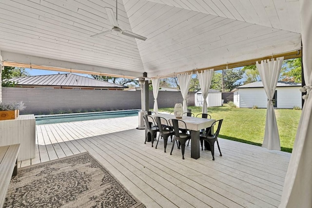 505 Heyser Dr, Dallas, TX 75224 - wooden terrace featuring an outbuilding, a fenced backyard, a lawn, a shed, and outdoor dining area