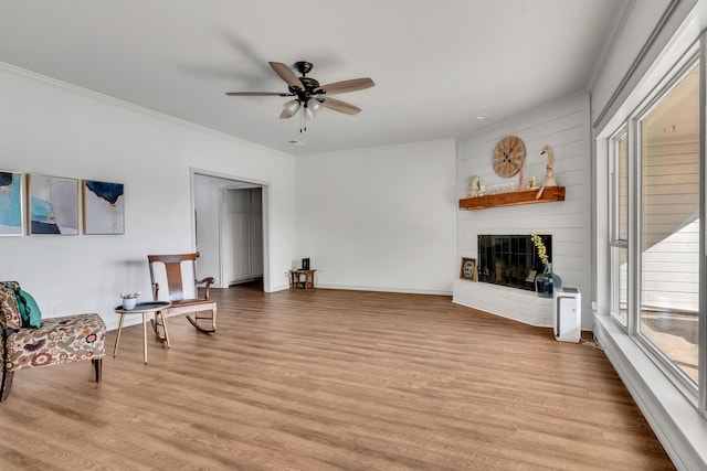 105 Park Trail Pl, Joshua, TX 76058 - unfurnished room featuring light wood finished floors, crown molding, a fireplace, a ceiling fan, and baseboards