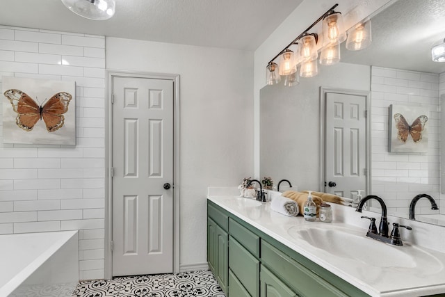 105 Park Trail Pl, Joshua, TX 76058 - bathroom featuring a textured ceiling, tile patterned flooring, double vanity, and a tub to relax in