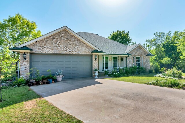 105 Park Trail Pl, Joshua, TX 76058 - ranch-style house with concrete driveway, covered porch, a garage, a front lawn, and brick siding