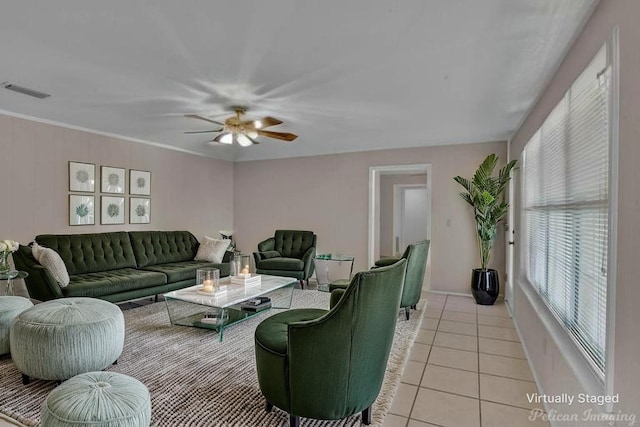 7321 Montclair Dr, Shreveport, LA 71105 - living area featuring plenty of natural light, light tile patterned floors, ceiling fan, and baseboards