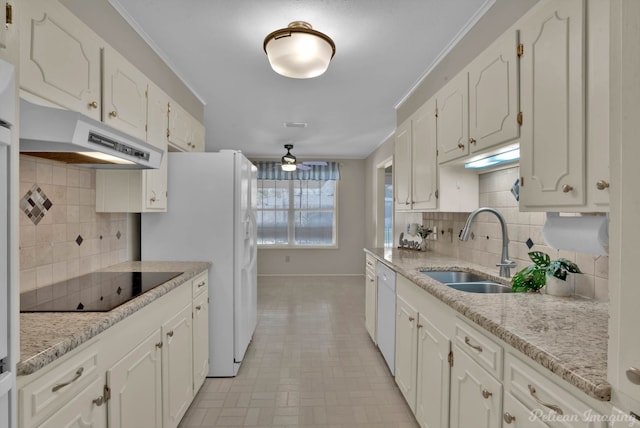 7321 Montclair Dr, Shreveport, LA 71105 - kitchen with under cabinet range hood, white appliances, baseboards, a sink, and white cabinets