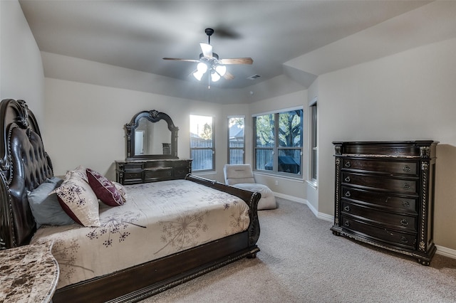 carpeted bedroom with baseboards, a ceiling fan, and visible vents